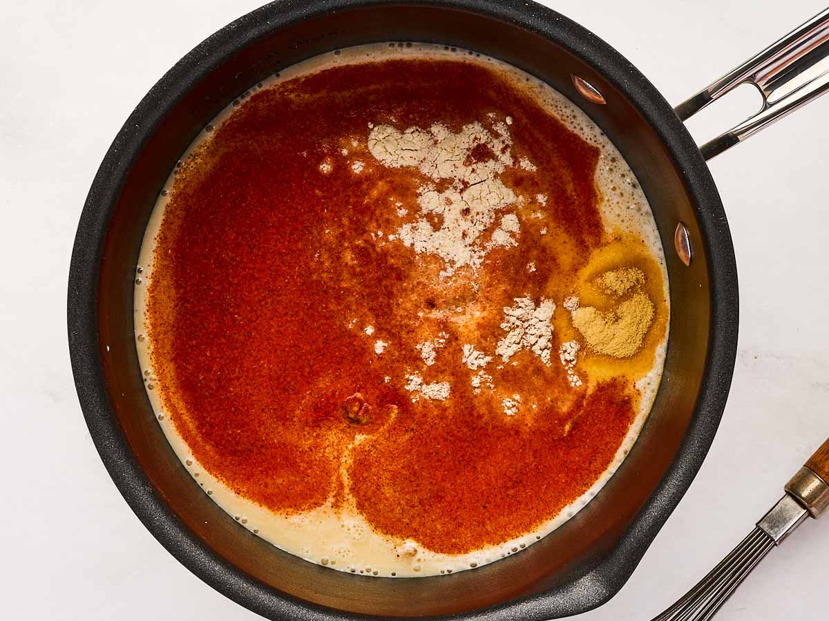 overhead view of adding dijon mustard and worcestershire sauce to saucepan