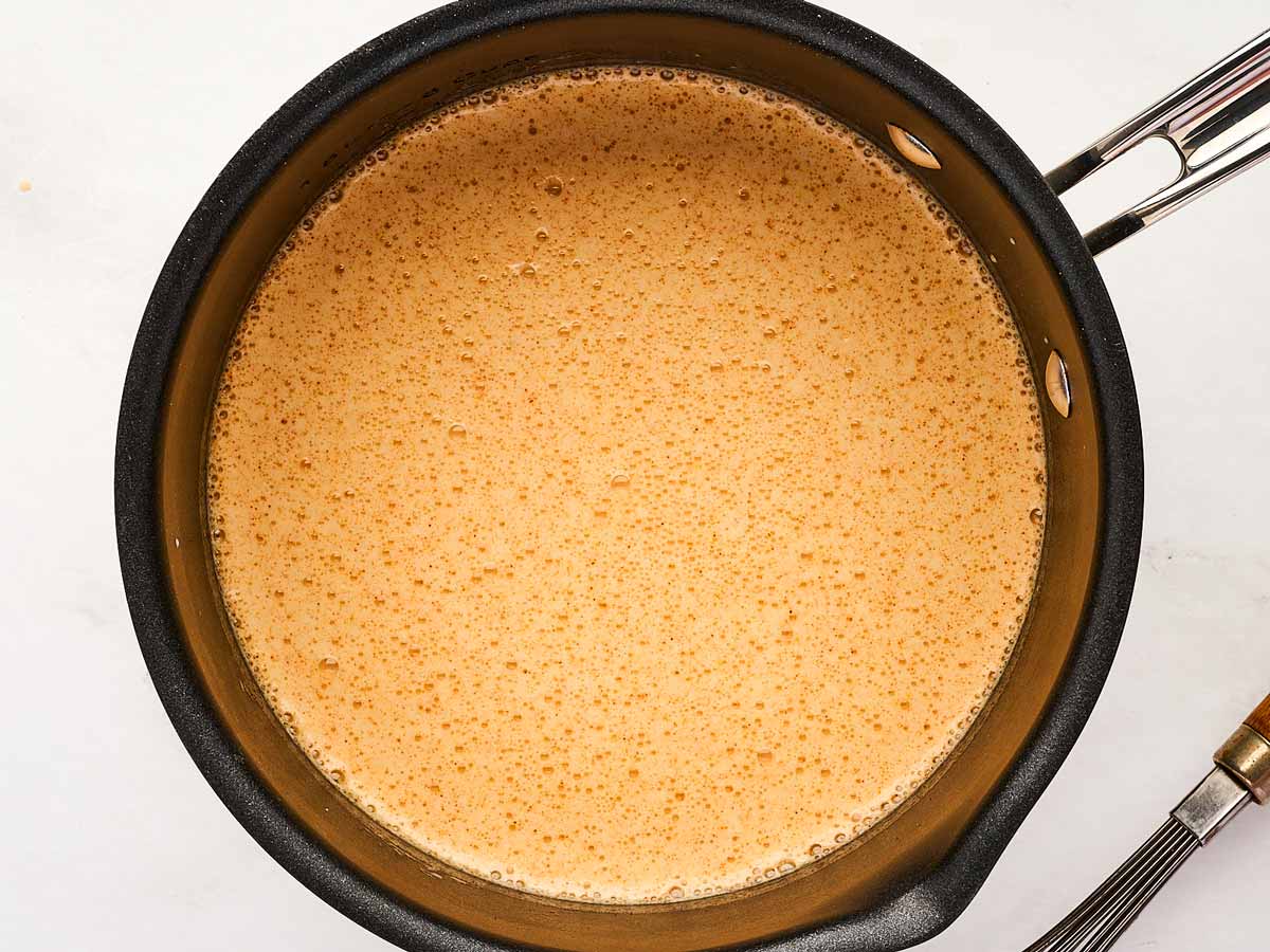 overhead view of saucepan with simmering beer and milk mixture