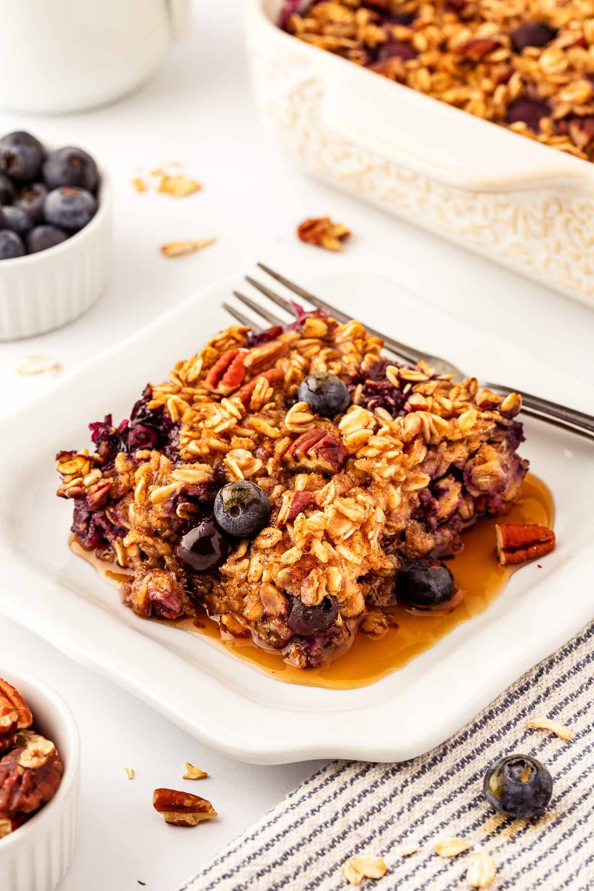 frontal view of blueberry baked oatmeal slice on white plate