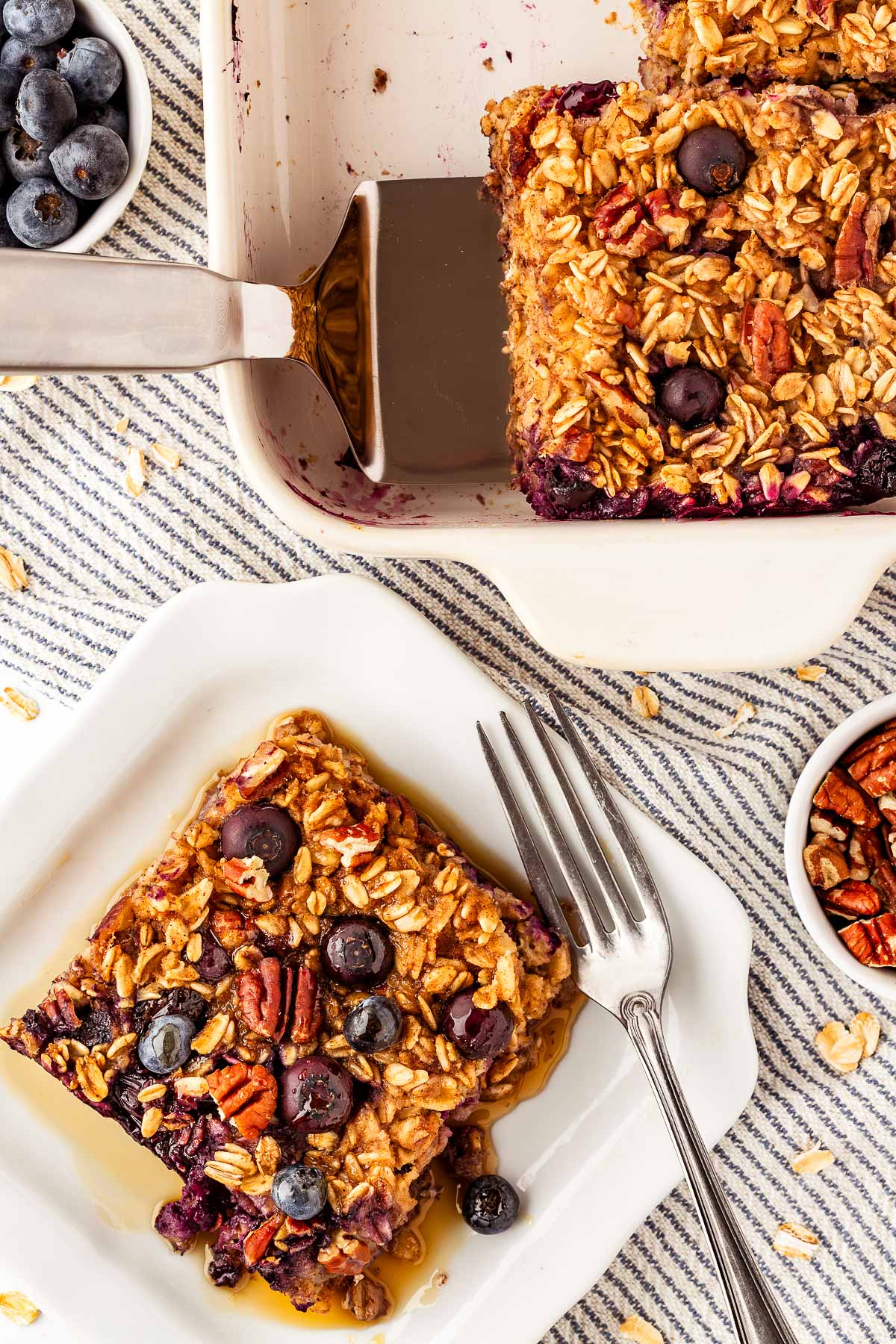 overhead view of blueberry oatmeal slice next to casserole dish