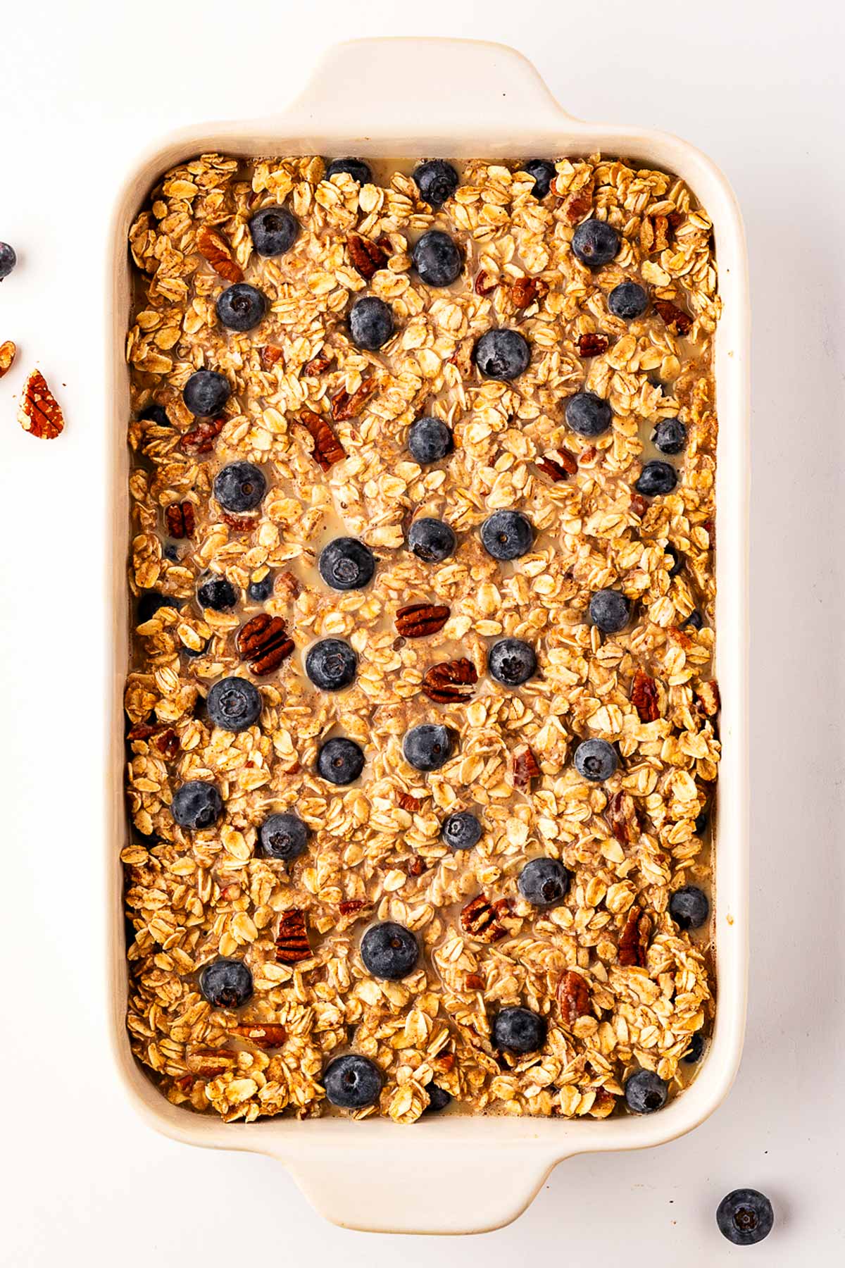 overhead view of unbaked blueberry oatmeal in baking dish