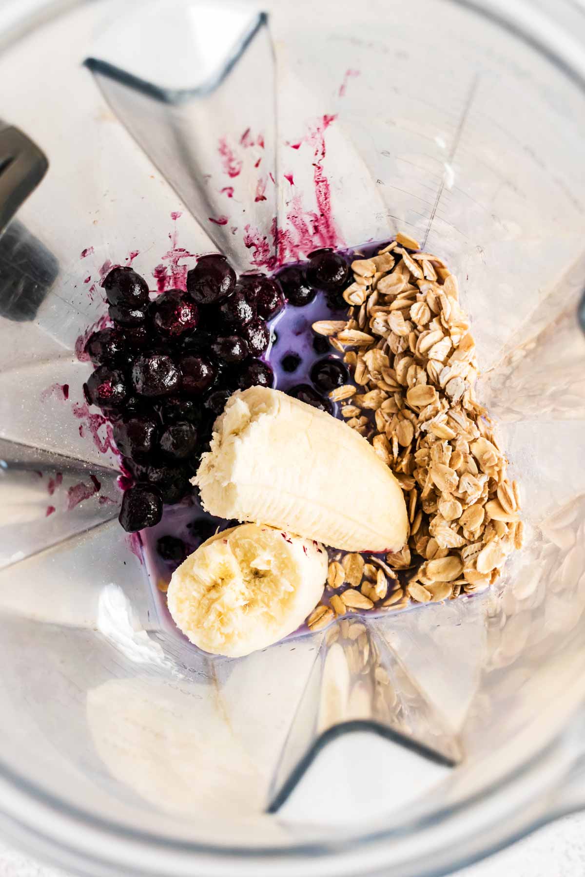 overhead view of blueberry smoothie ingredients in blender