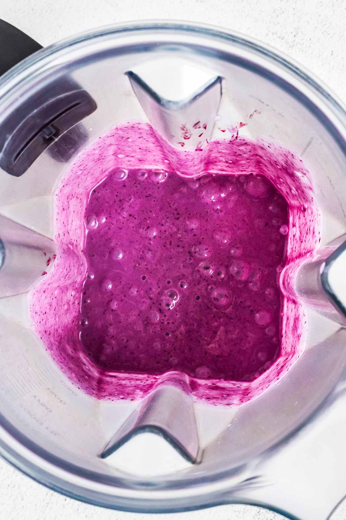 overhead view of blueberry smoothie in blender