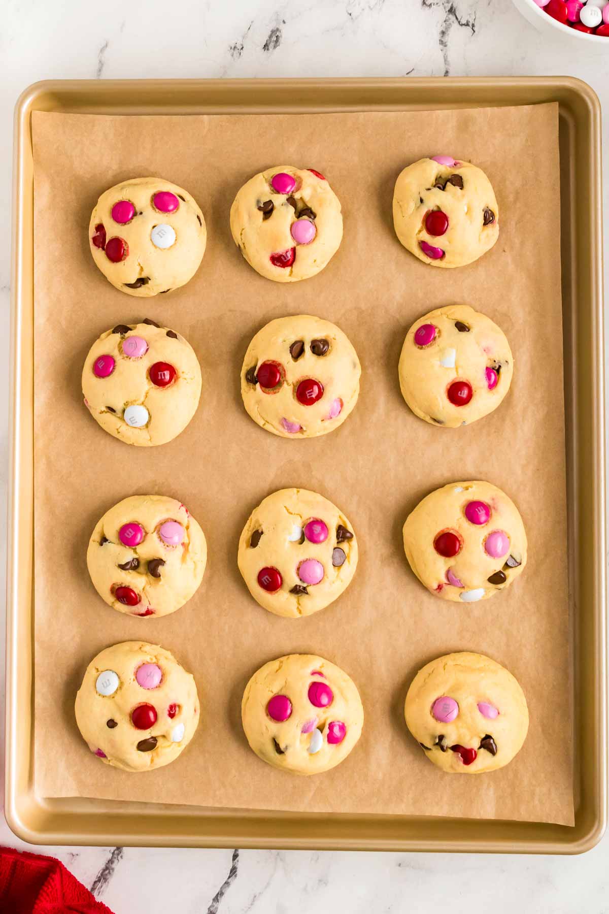 overhead view of Valentine's Day cake mix cookies on cookie sheet