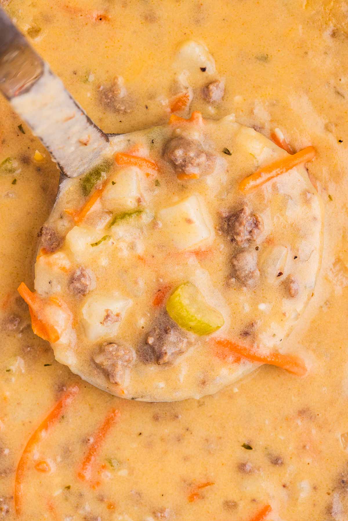 overhead view of ladle with cheeseburger soup