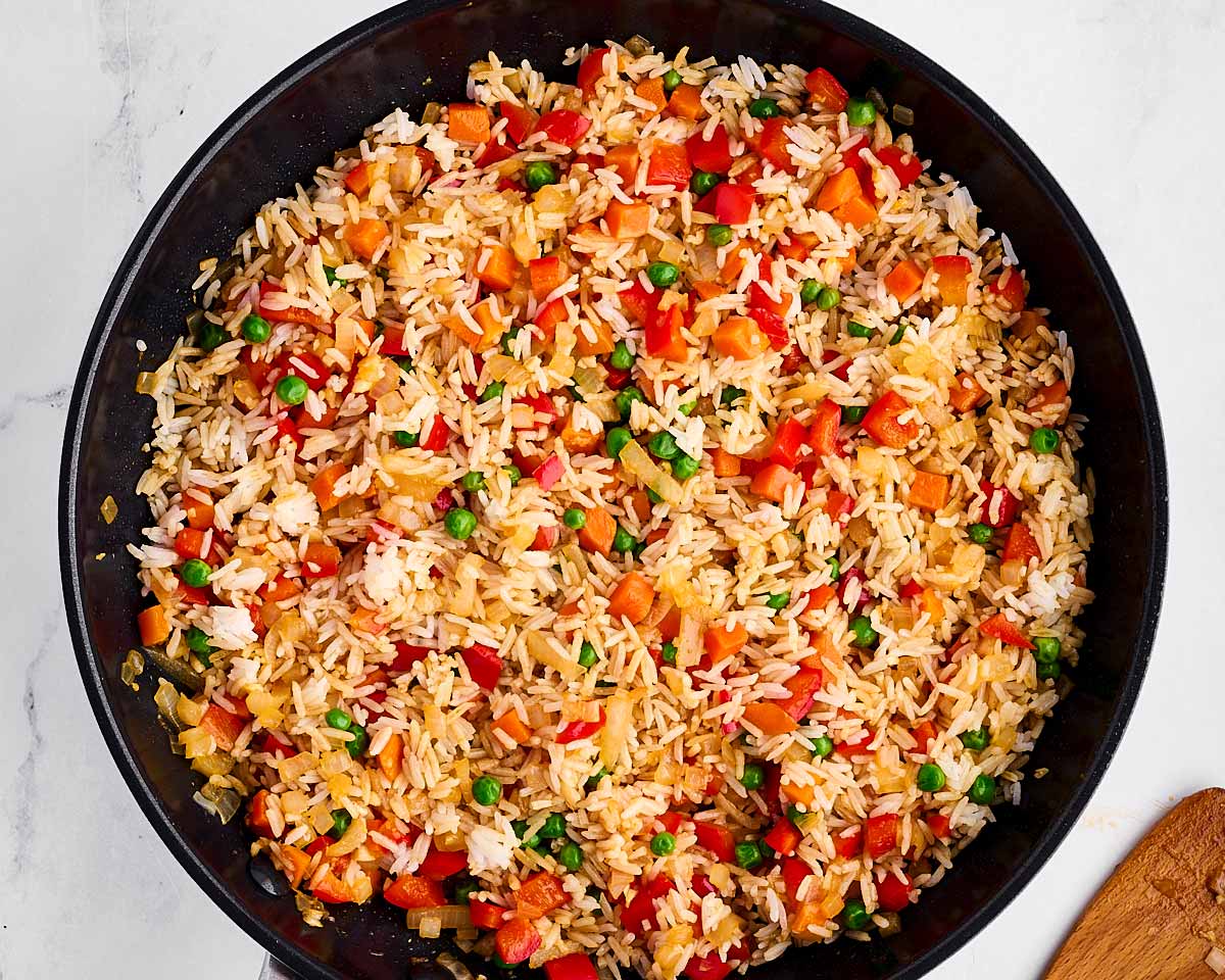 overhead view of vegetables and rice mixed together in skillet