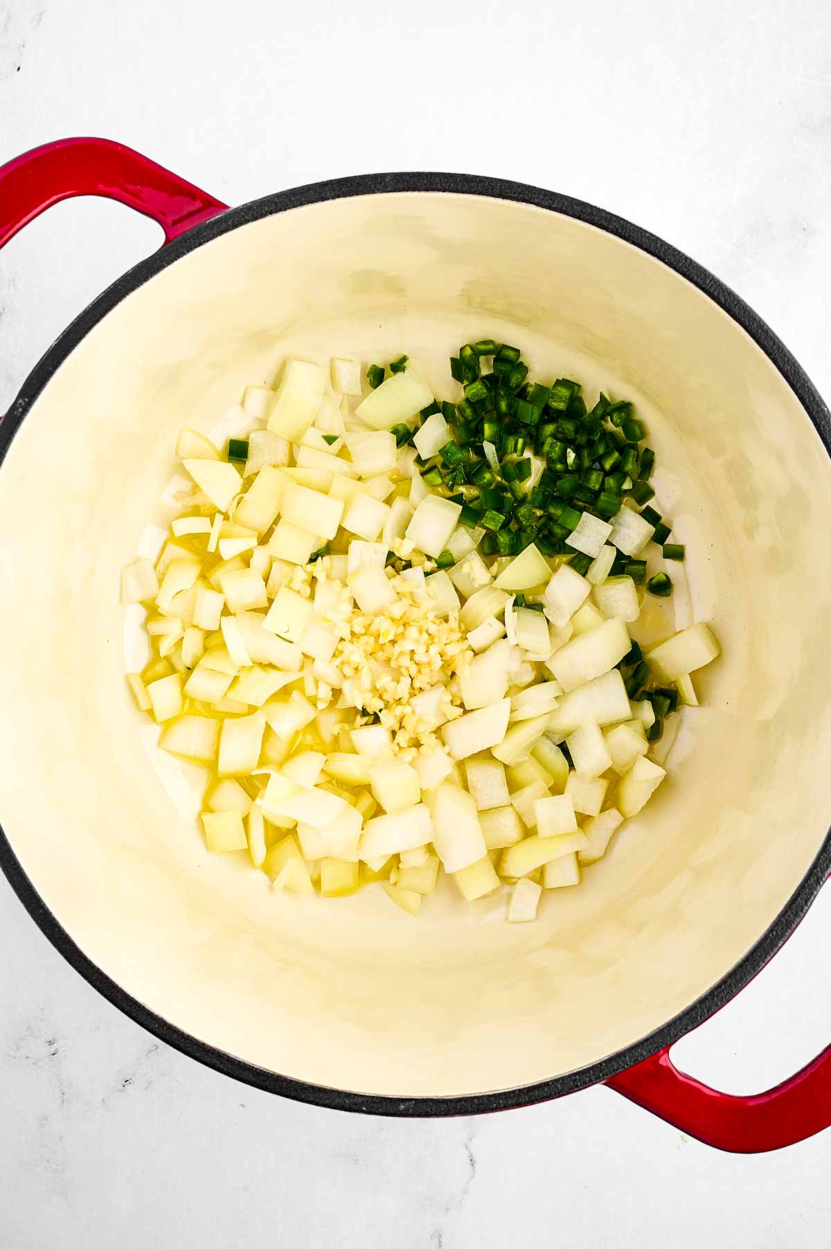 overhead view of uncooked aromatics in pot