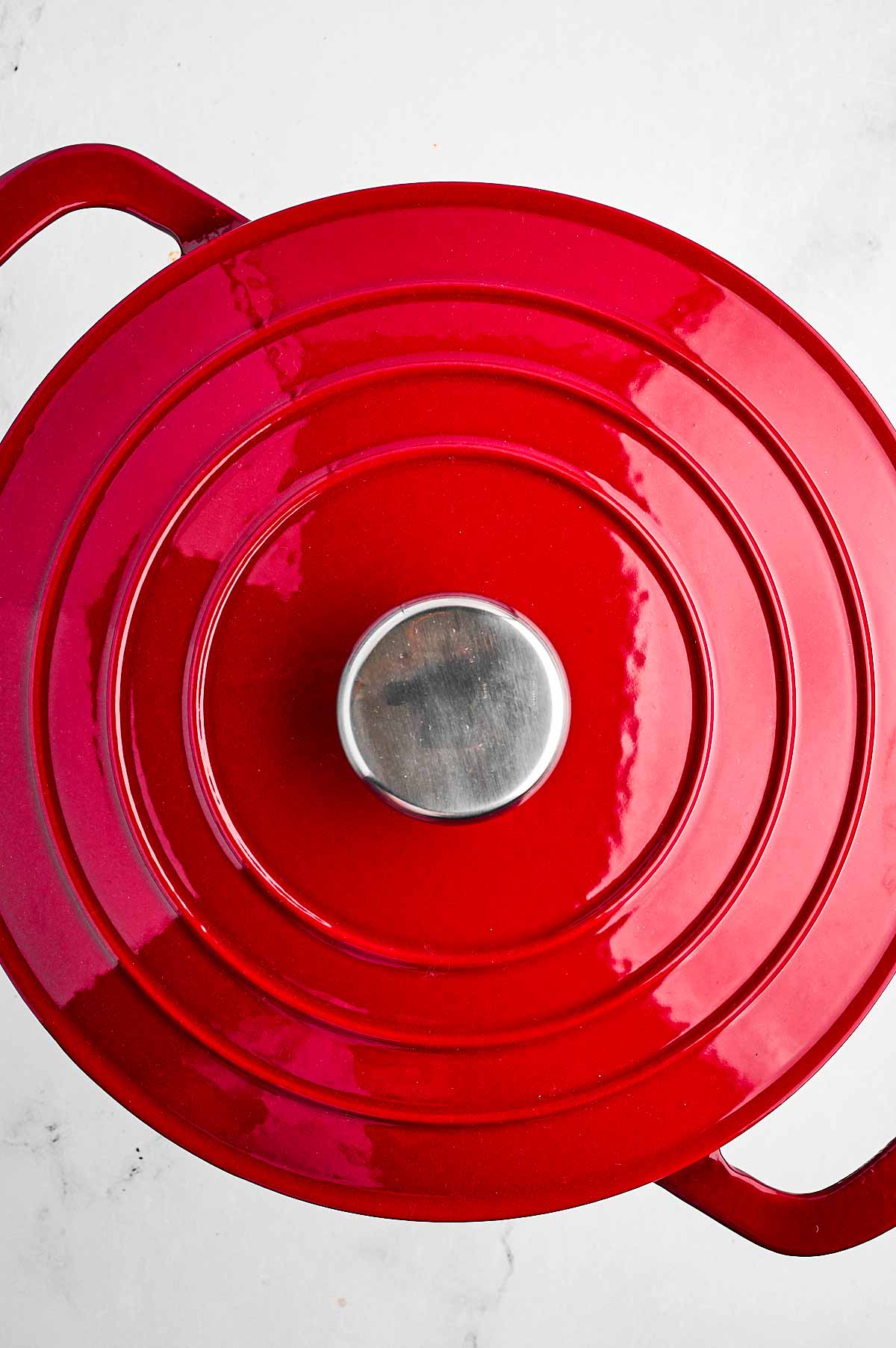 overhead view of red dutch oven with lid