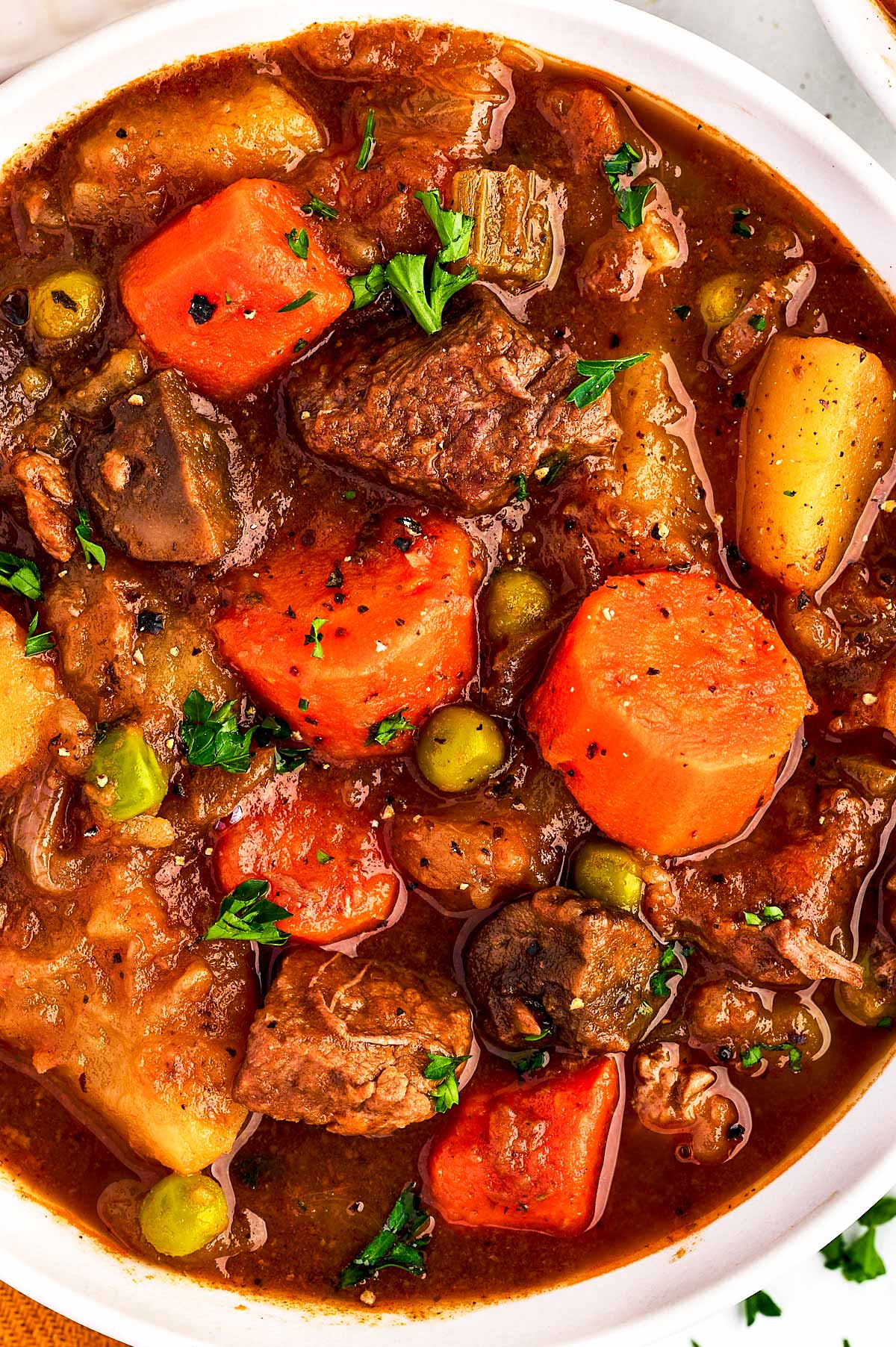 overhead close up view of beef stew in white bowl