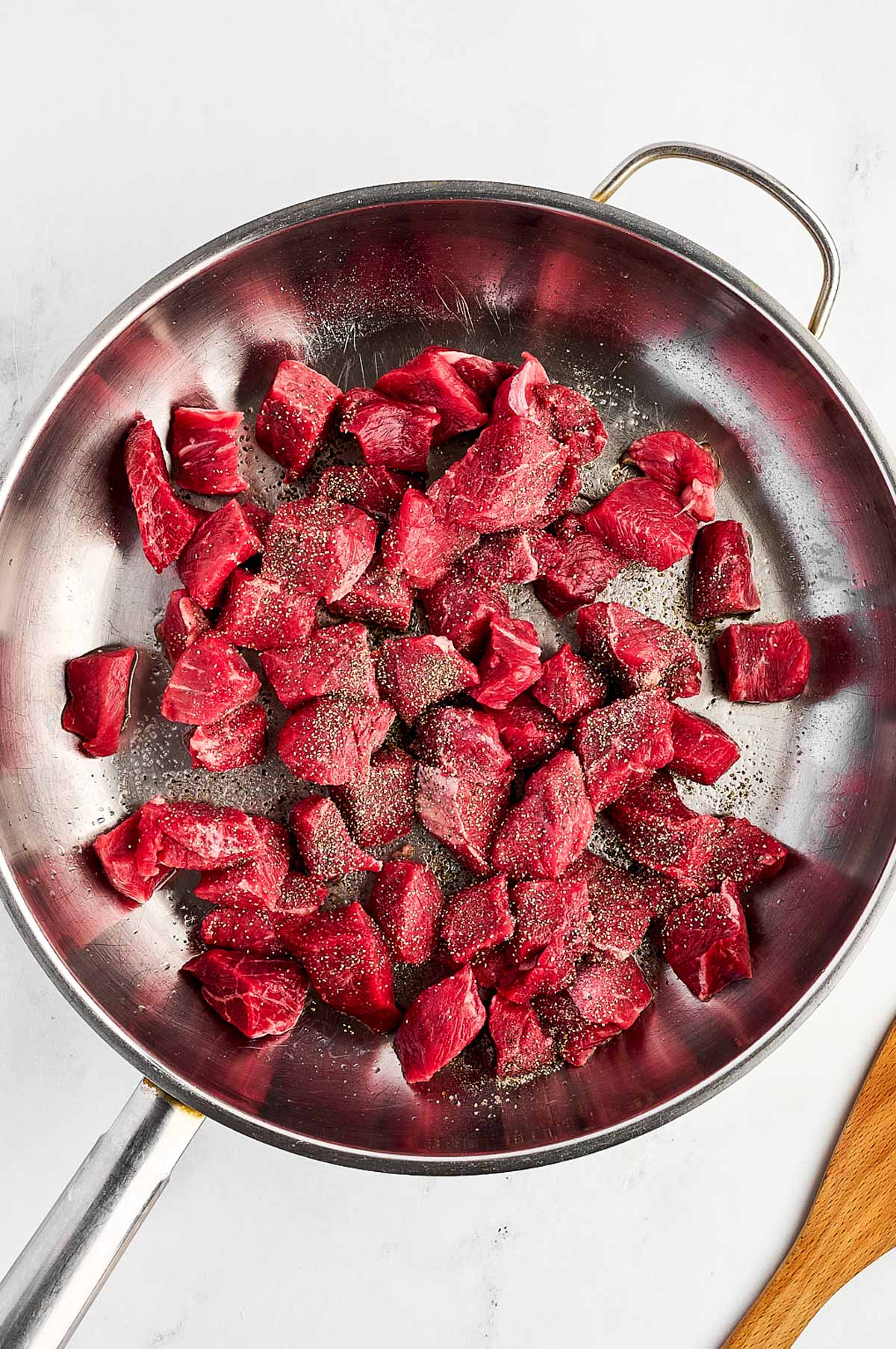 overhead view of raw beef in skillet