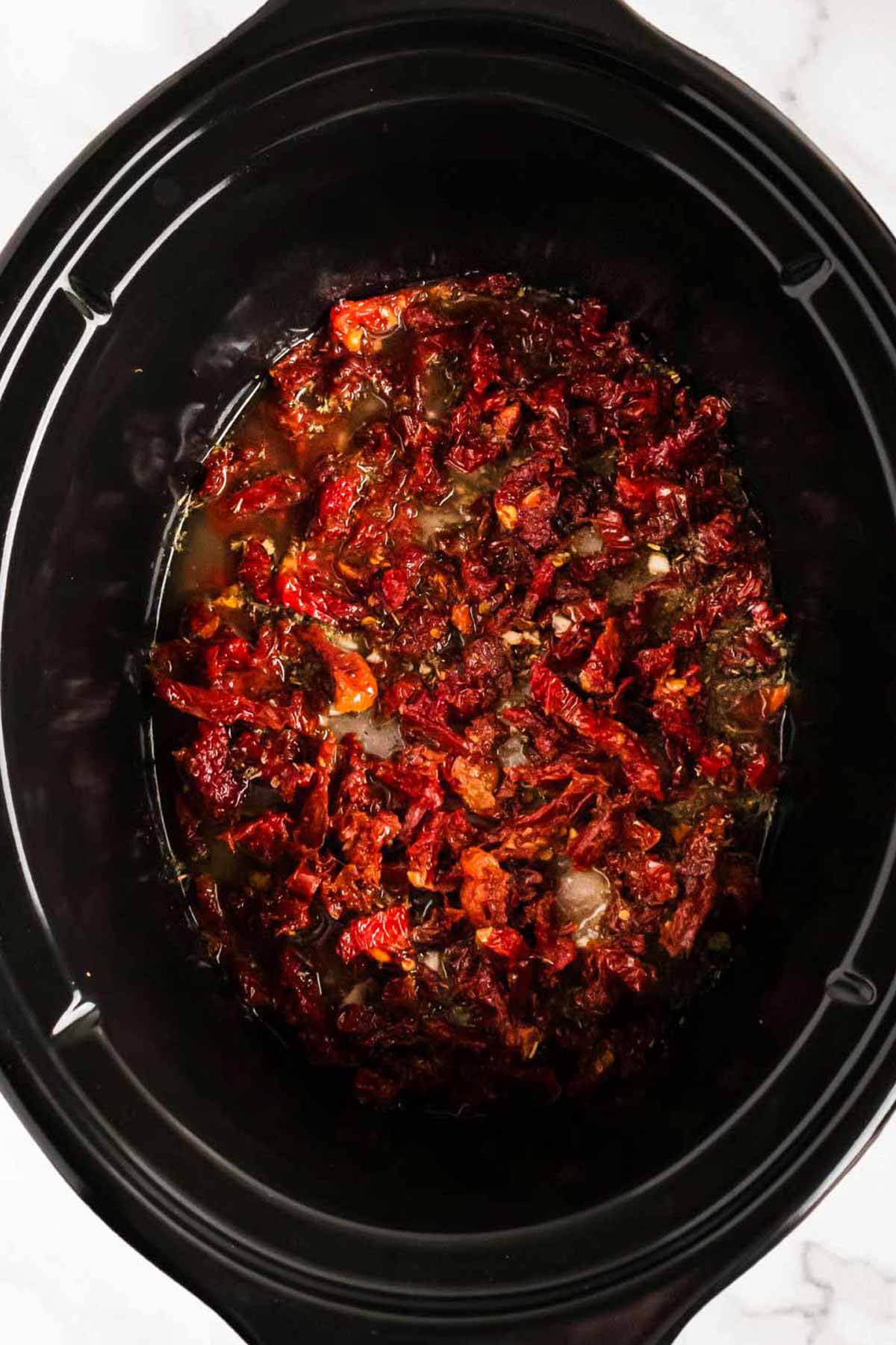 overhead view of sun-dried tomatoes in slow cooker