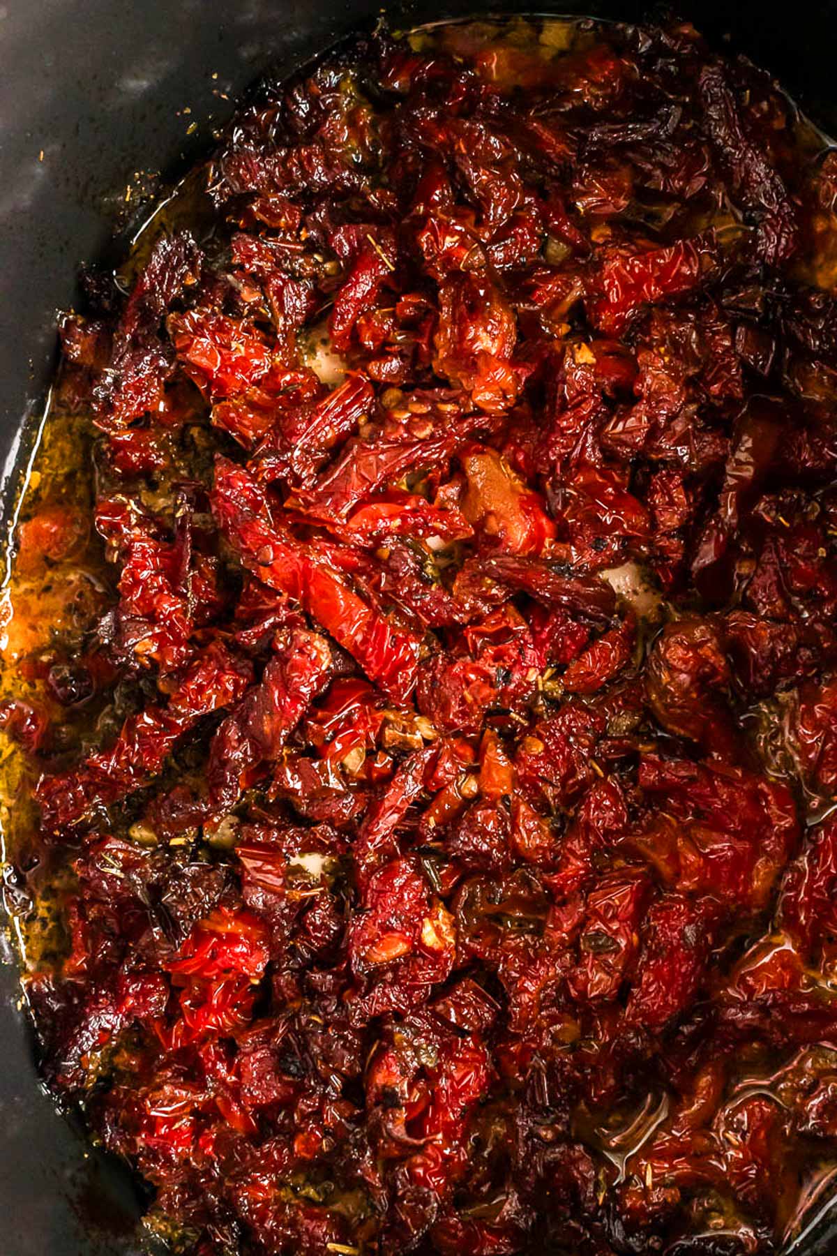 overhead close up view of sun-dried tomatoes in slow cooker