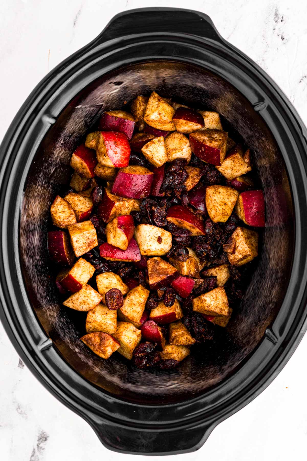 overhead view of apples in slow cooker crockery insert