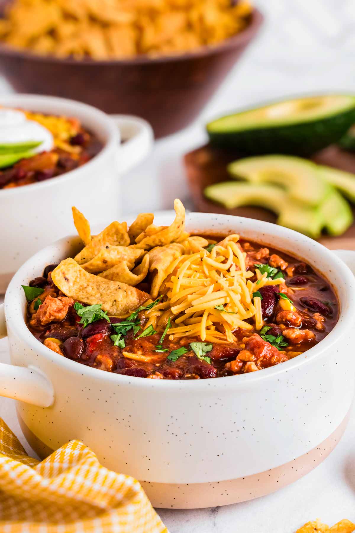 frontal view of bowls with turkey chili and toppings