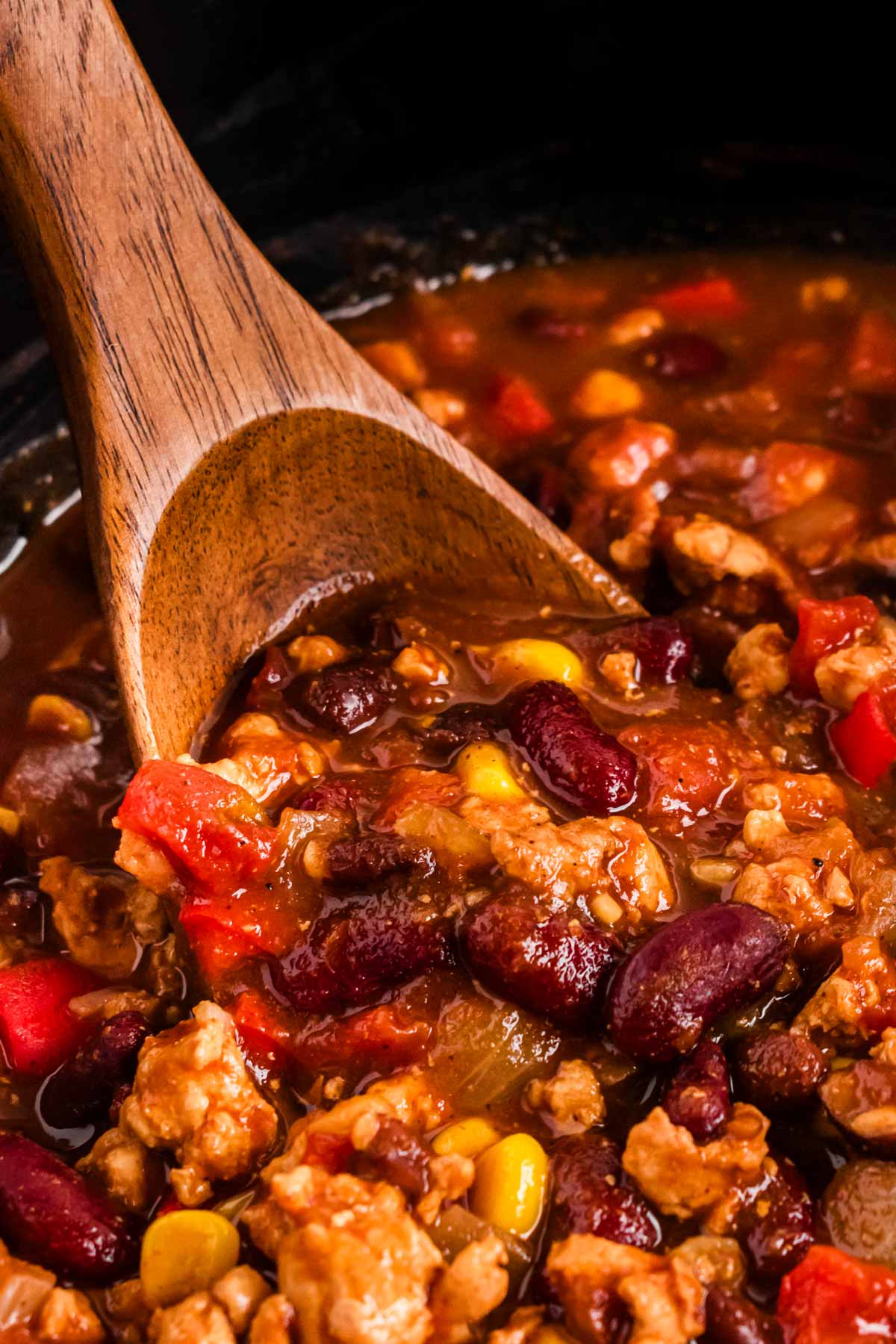 frontal close up of spoon in turkey chili