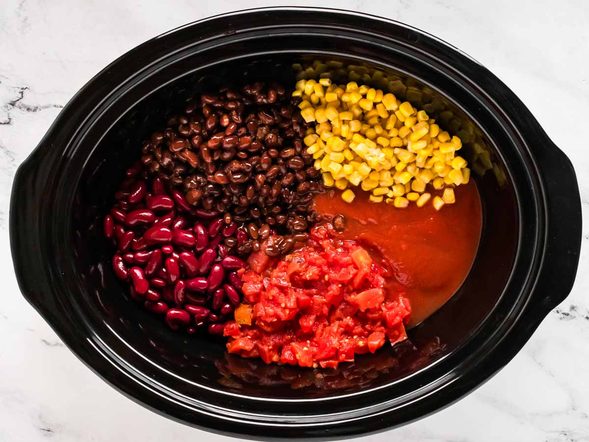 overhead view of chili ingredients in slow cooker