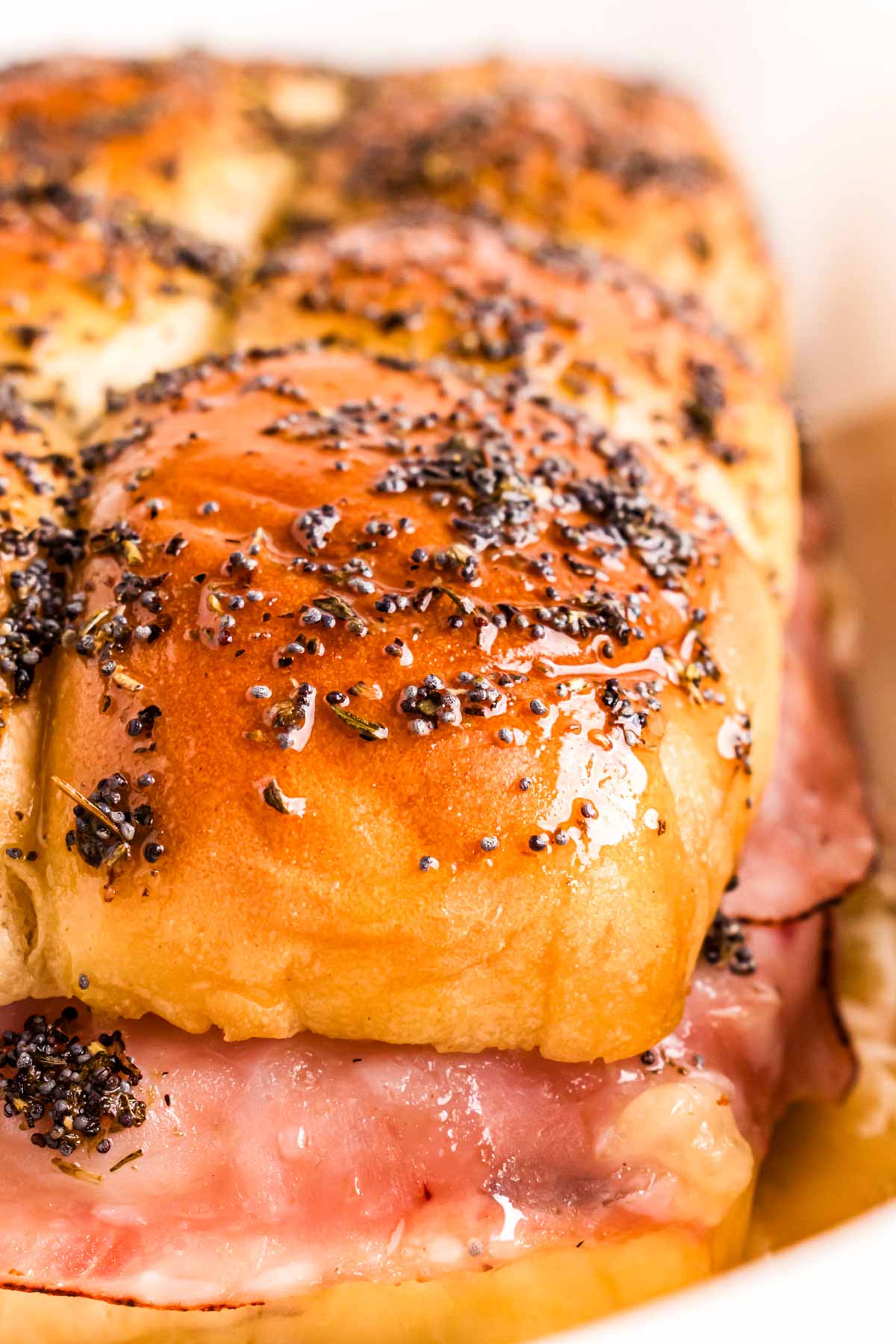 frontal close up view of baked ham and cheese sliders