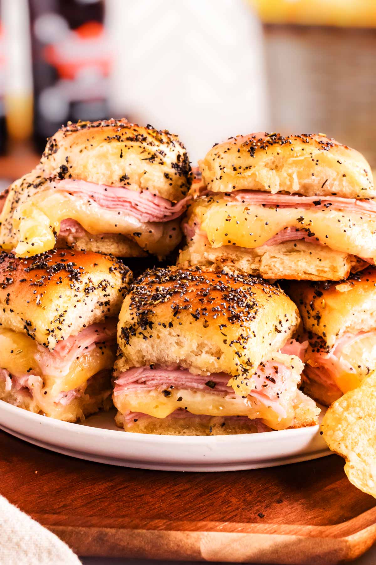 frontal view of ham sliders stacked on plate