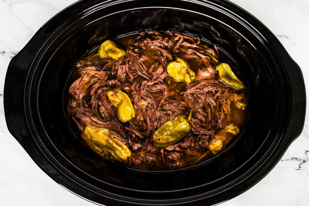 overhead view of shredded Mississippi pot roast in slow cooker