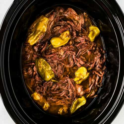 overhead close up view of Mississippi pot roast in black slow cooker crock