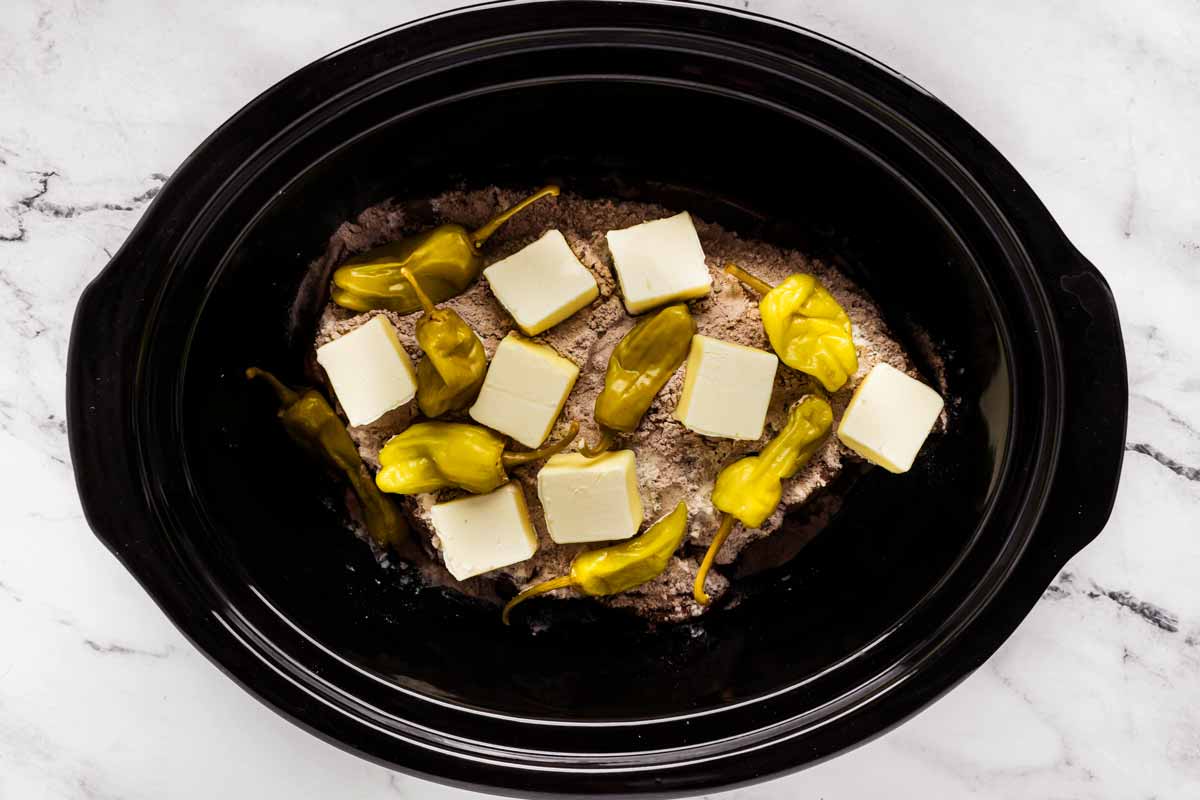 overhead view of butter and pepperoncini on seasoning mix