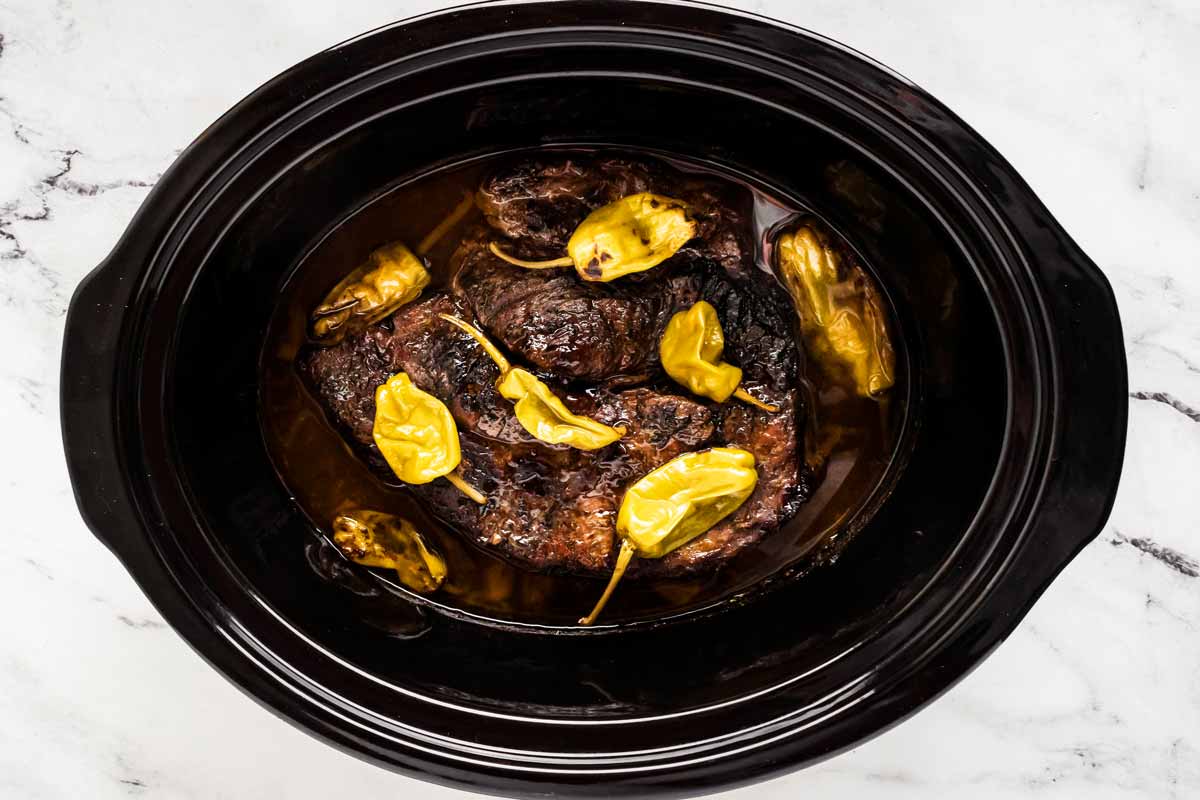 overhead view of cooked Mississippi pot roast in slow cooker