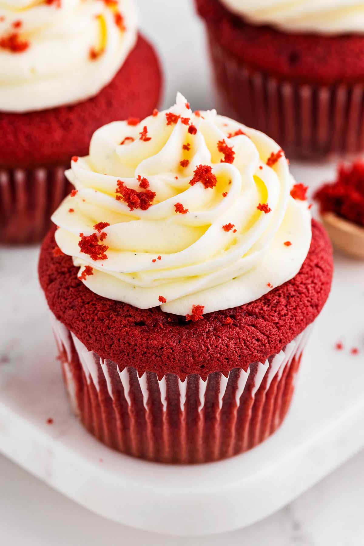 frontal angled view of red velvet cupcake with frosting