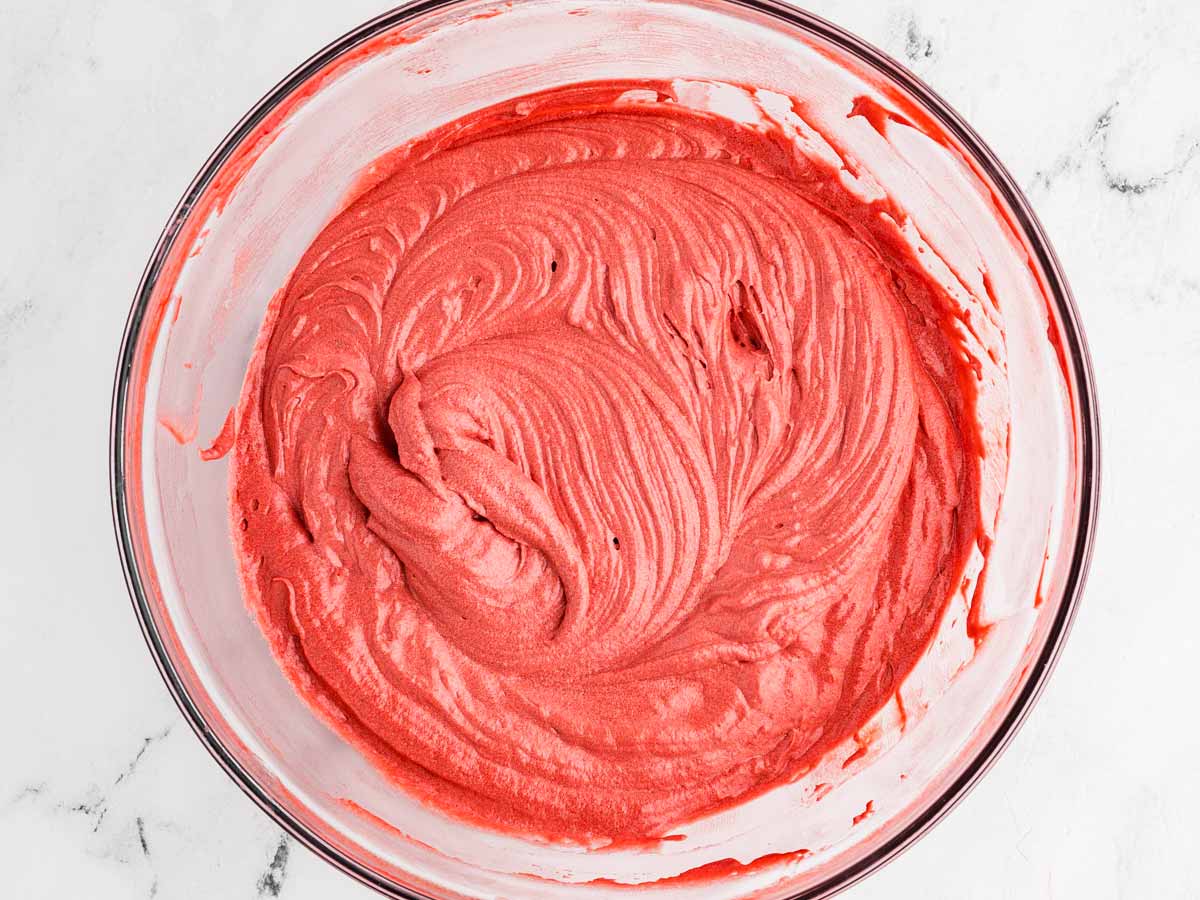 overhead view of batter for red velvet cupcakes in glass bowl