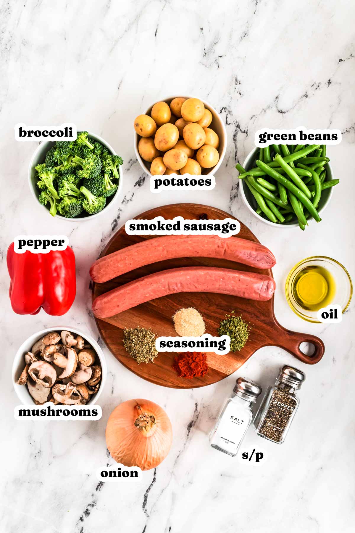 overhead view of ingredients for sheet pan sausage and vegetables with text labels