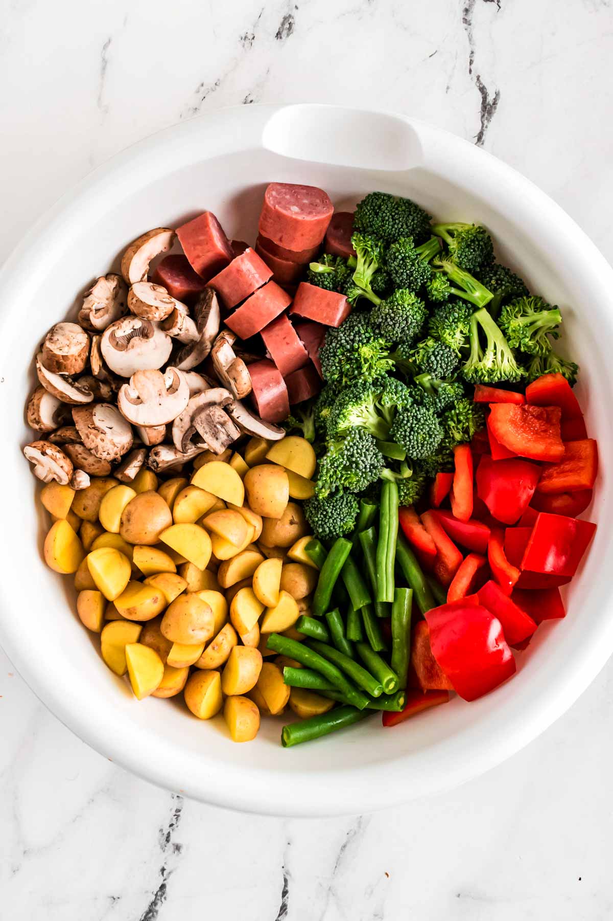 overhead view of cut up vegetables in bowl