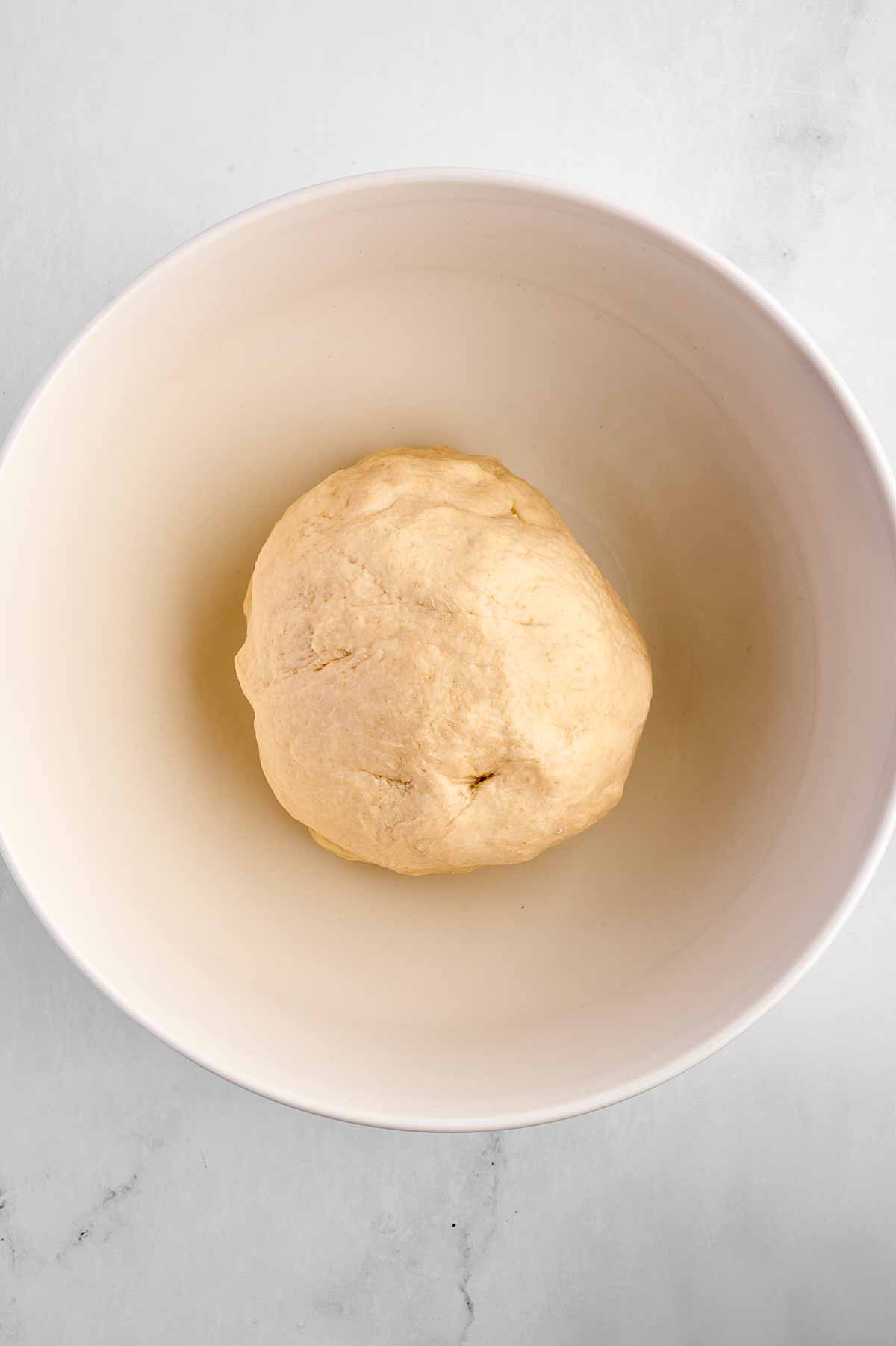 overhead view of unrisen dough in bowl