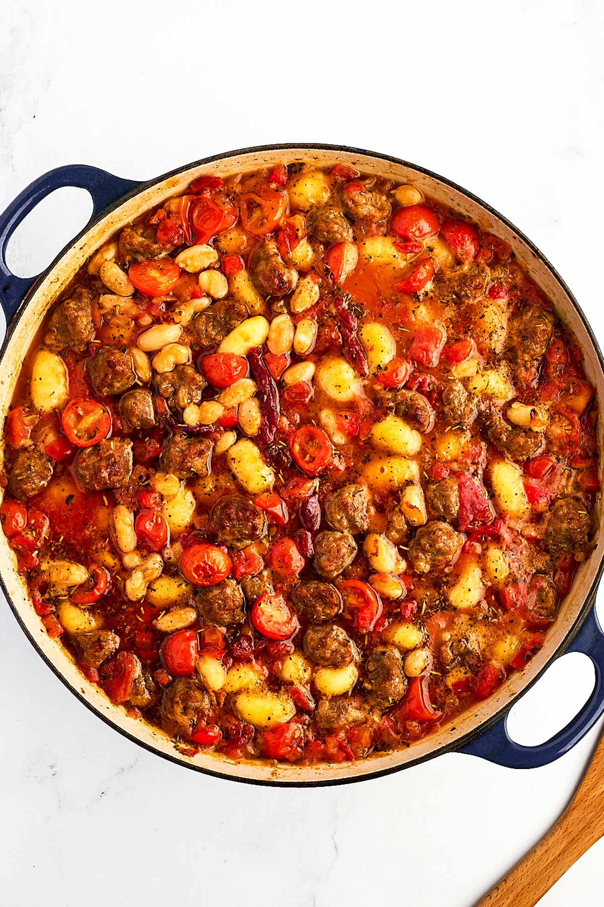 overhead view of baked gnocchi mixture bubbling in dutch oven fresh from the oven