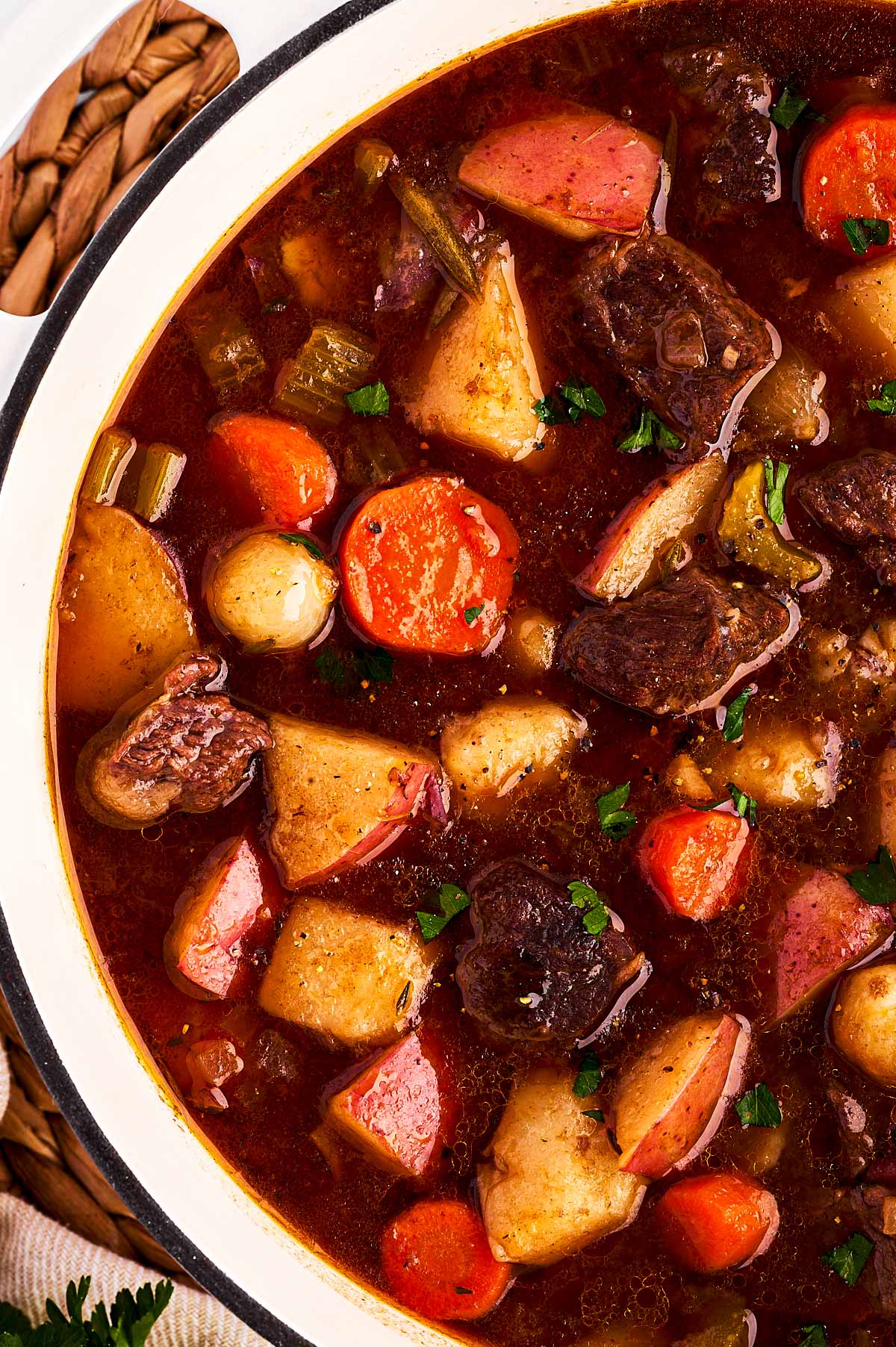 overhead close up view of white Dutch oven filled with beef stew