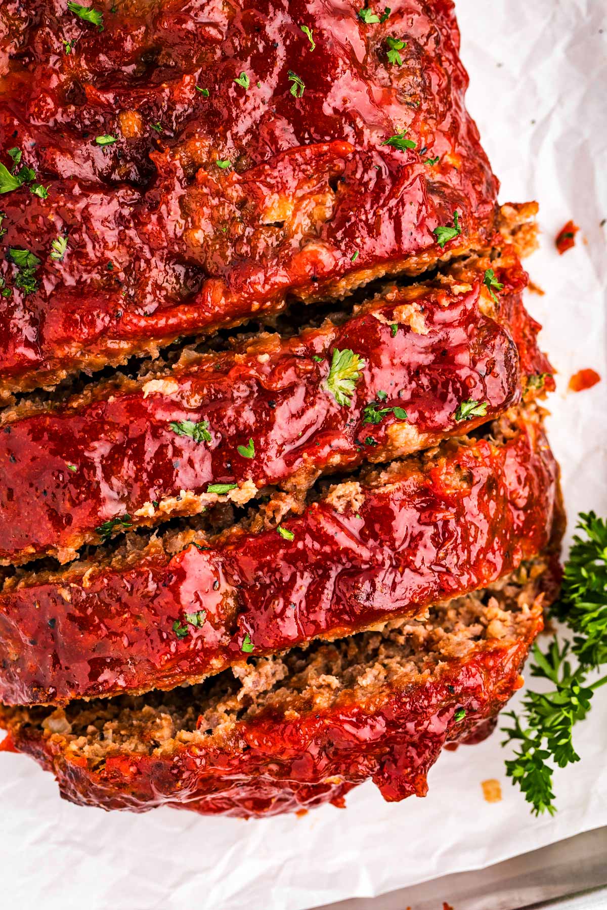 overhead view of sliced meatloaf on white platter