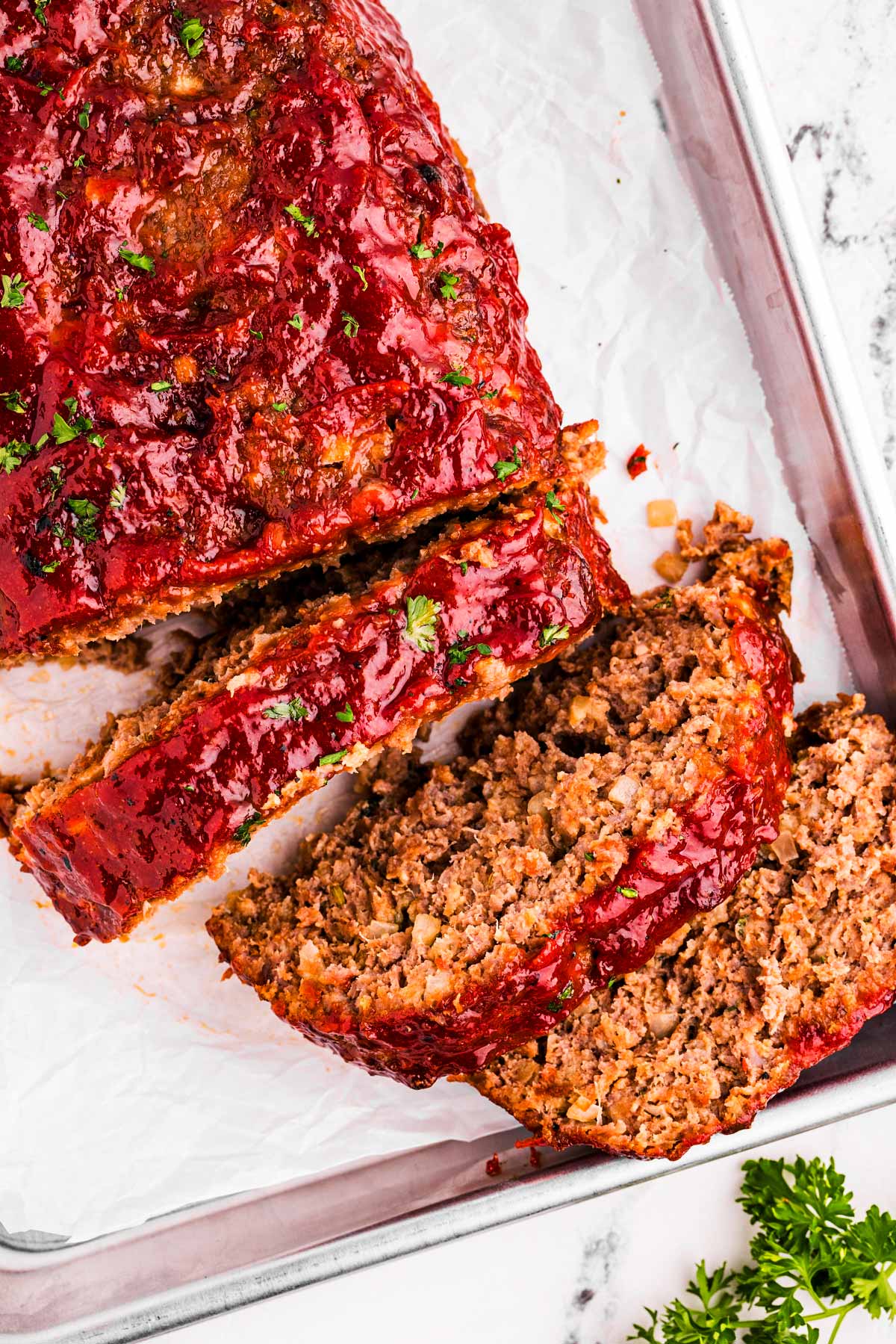 overhead view of sliced meatloaf on lined pan