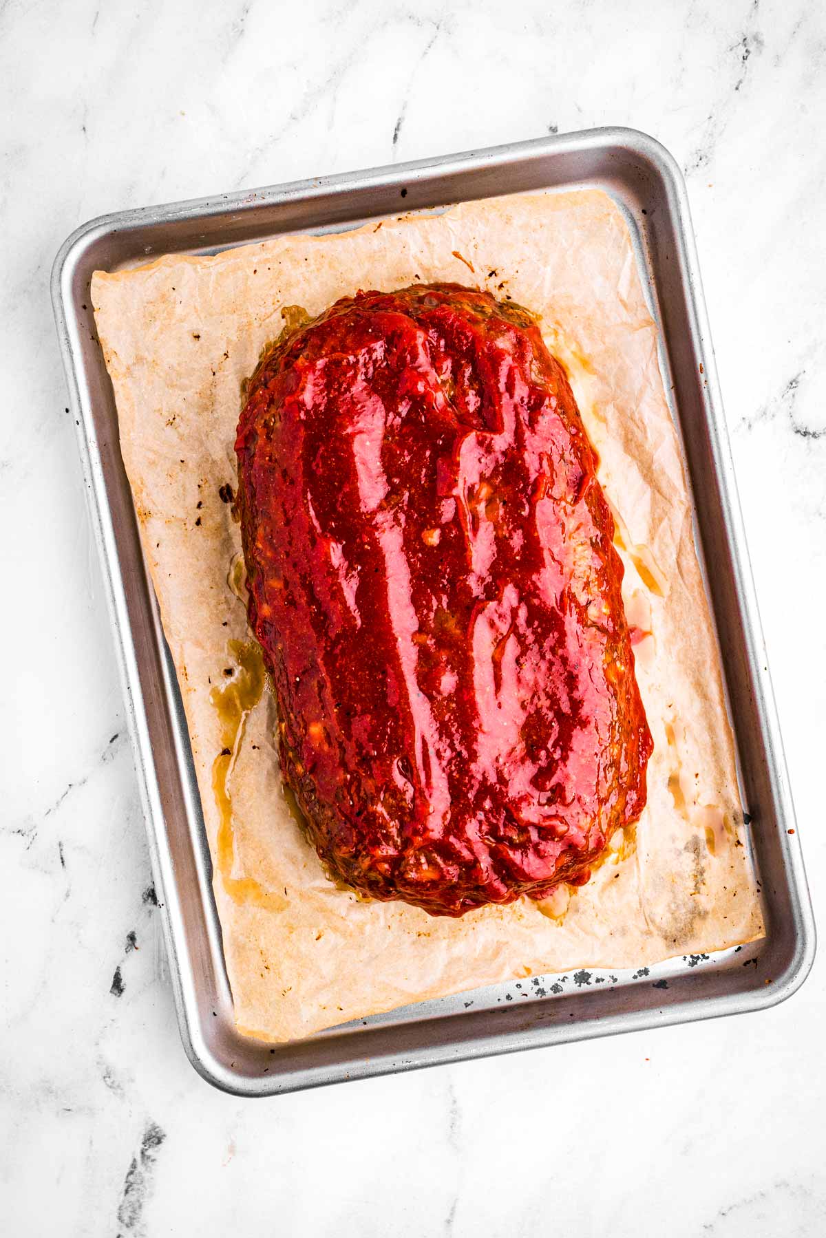 overhead view of glazed almost finished baking meatloaf