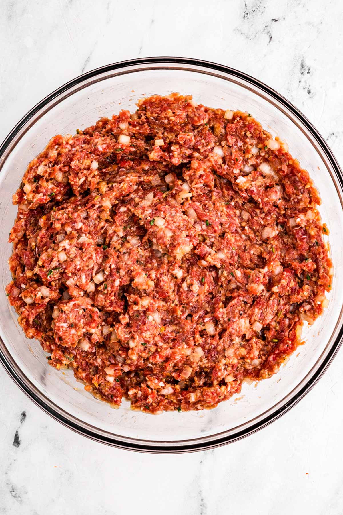 overhead view of meatloaf mixture in glass bowl