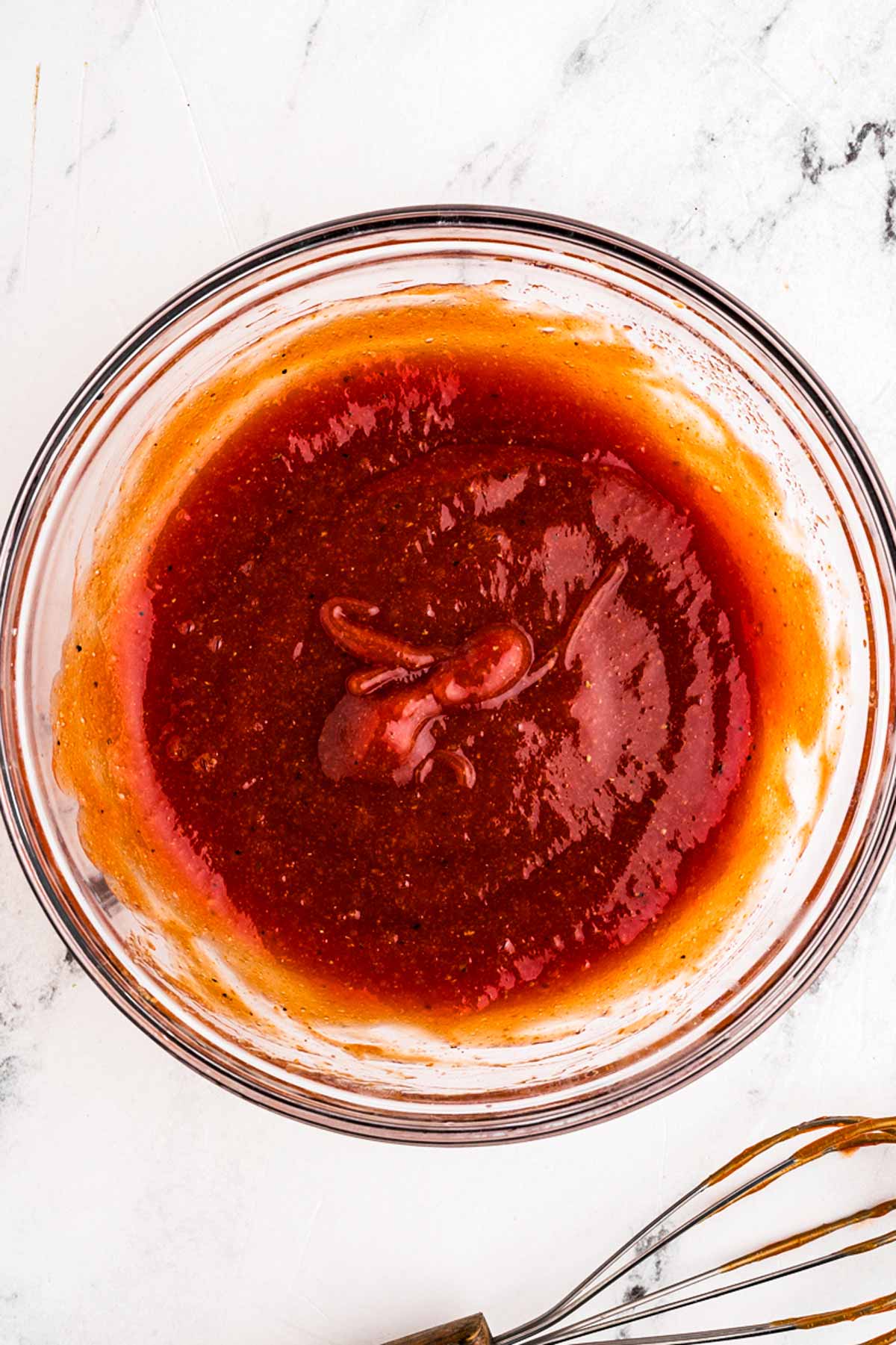 overhead view of meatloaf sauce in glass bowl