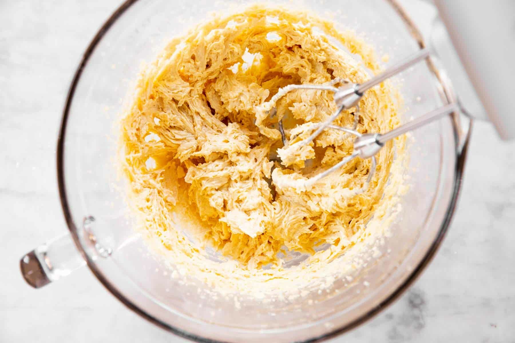 glass bowl with creamed butter, sugar and eggs