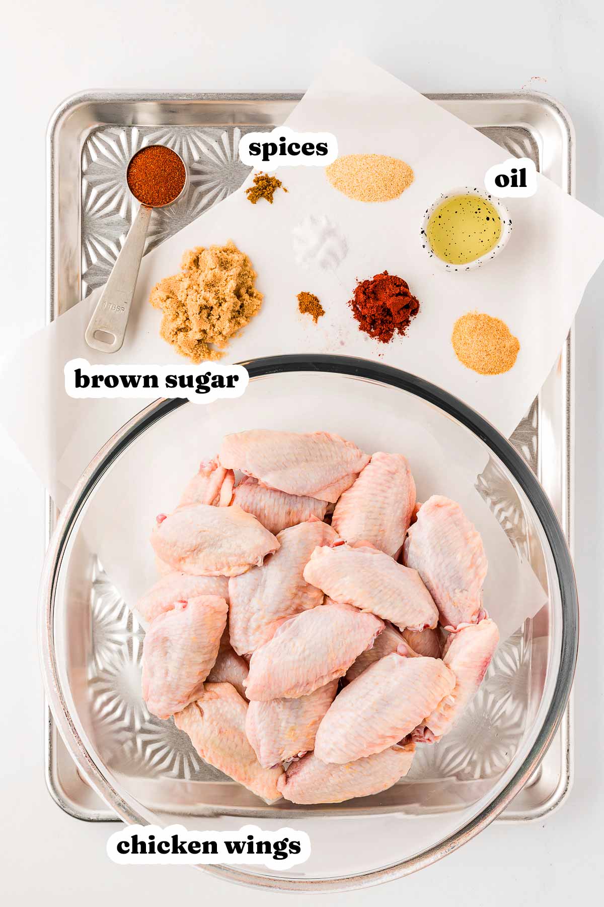 overhead view of ingredients to make baked chicken wings with text labels