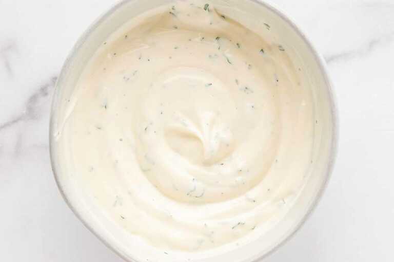 overhead view of chicken salad dressing in white bowl