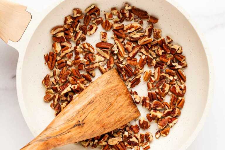 overhead view of pecans being roasted in skillet