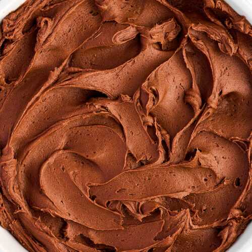 overhead view of chocolate buttercream frosting in white bowl