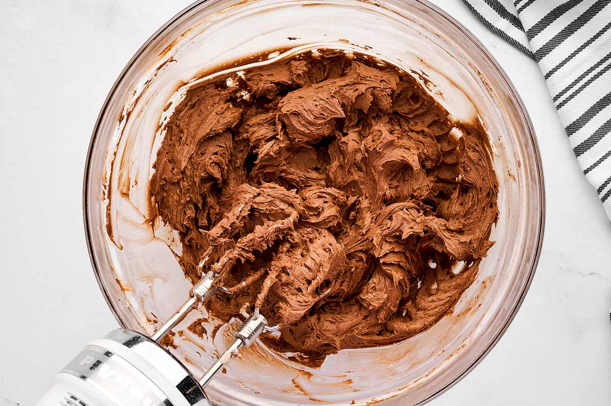 overhead view of chocolate buttercream frosting in bowl