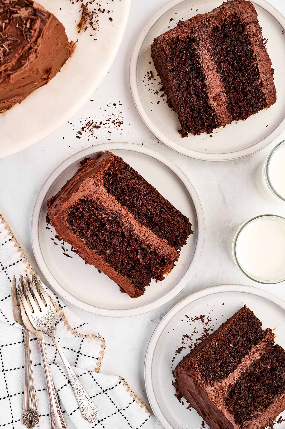 overhead view of several chocolate cake slices on plates