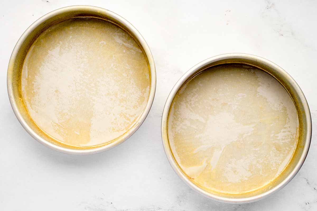 overhead view of two lined and greased cake pans