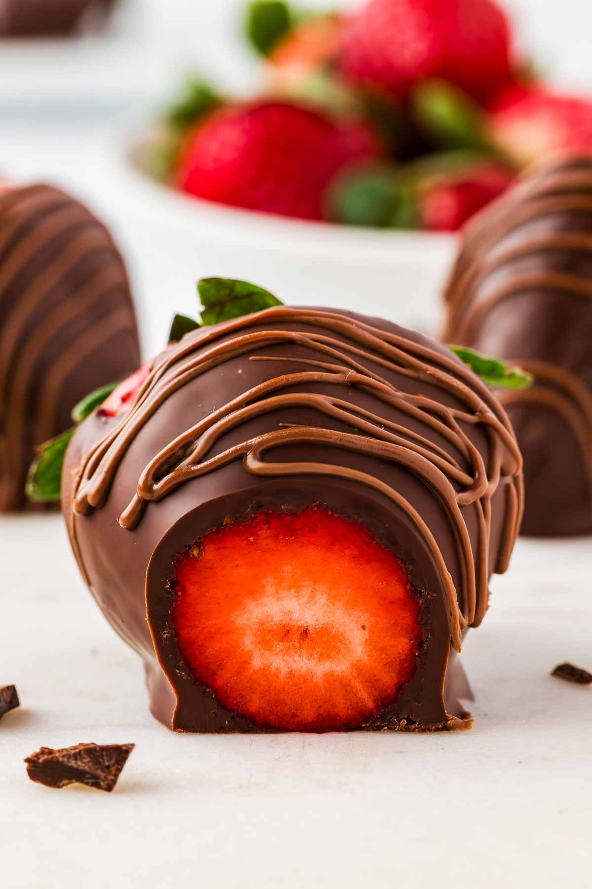 frontal view of sliced open chocolate covered strawberry