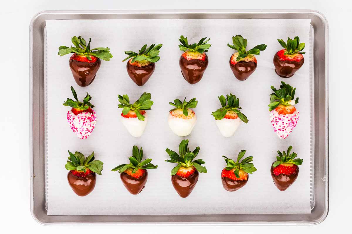 overhead view of chocolate covered strawberries on lined baking sheet