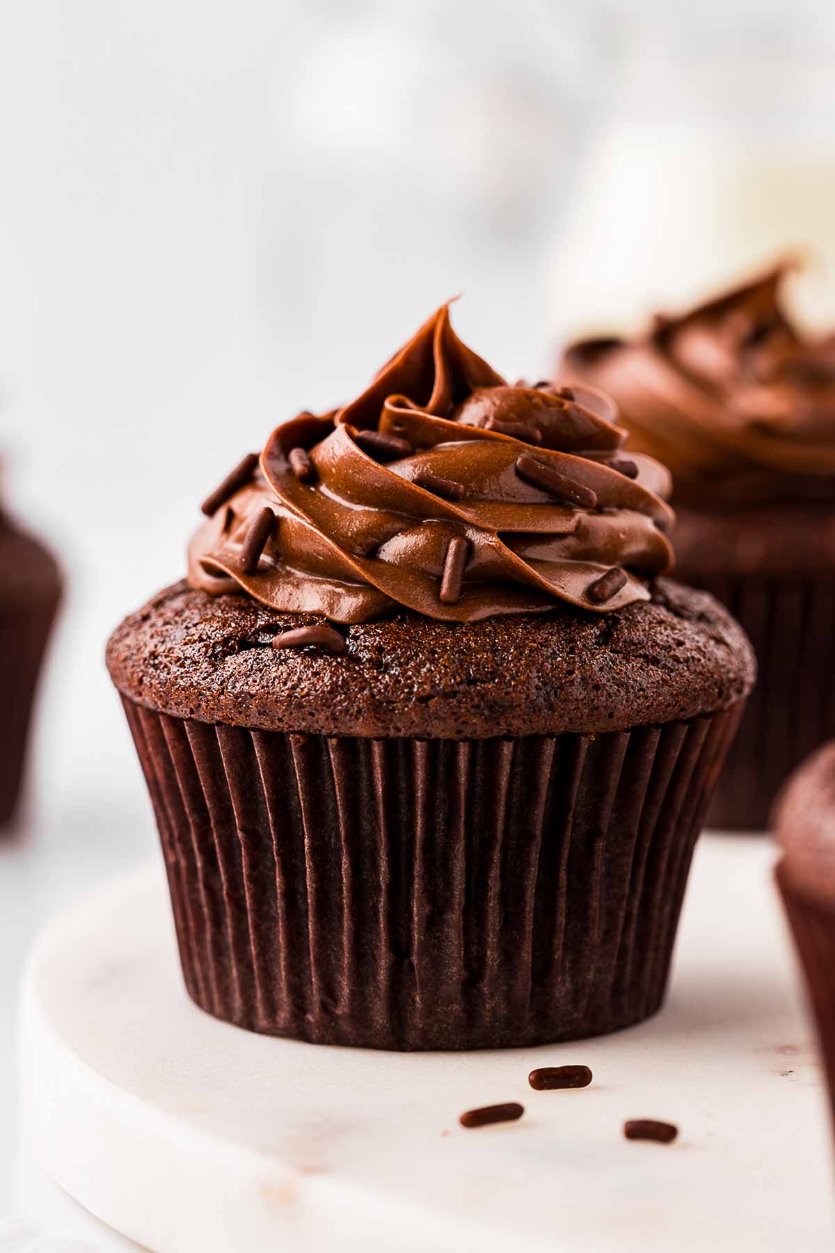 frontal view of chocolate cupcake topped with whipped ganache frosting