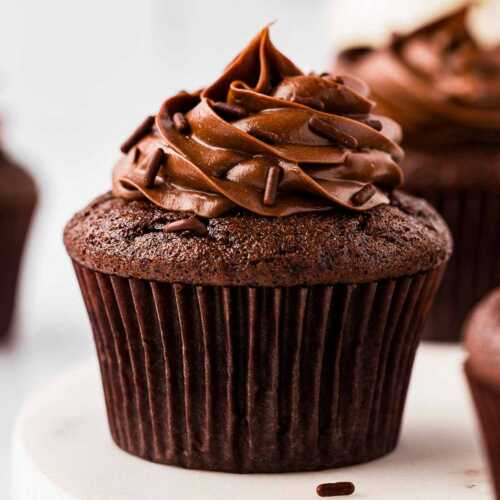 frontal view of chocolate cupcake topped with whipped ganache frosting